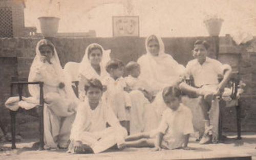 Left to right, back row: Sisters Nirmal and Kamla, mother with Vijay brother in her lap, cousin Krishan Gopal Anand. Middle row: Brother Ashok. Front row: Brother Inder and his friend Rameshwar. Just before the partition of India.