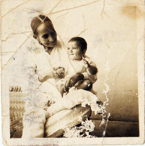My frail mother, Beeji, (6 sons, 2 daughters) with one of her grandchildren. Early 1950s.