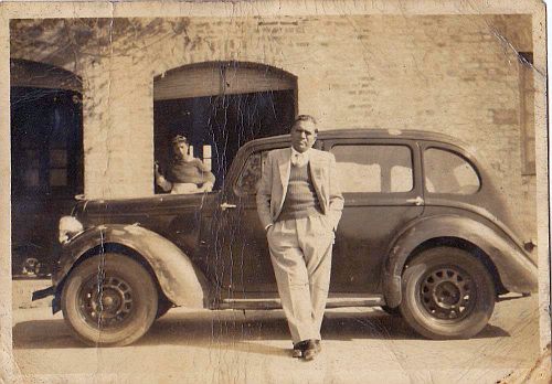 My father-in-law, S.N. Sikand, in front of his old model car, with his older daughter at the back.