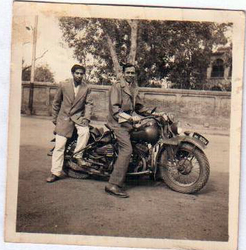 Flying Officer J. M. Massey on his Harley Davidson motorcycle with his orderly, Nazir. 1947