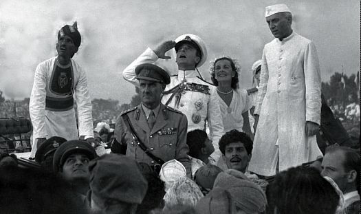  Lord Mountbatten saluting the Indian flag, with Lady Mountbatten and Nehru to his left.