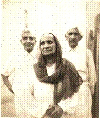 Centre, my mother (Biji)\; behind, my father (Pitaji), and his brother.