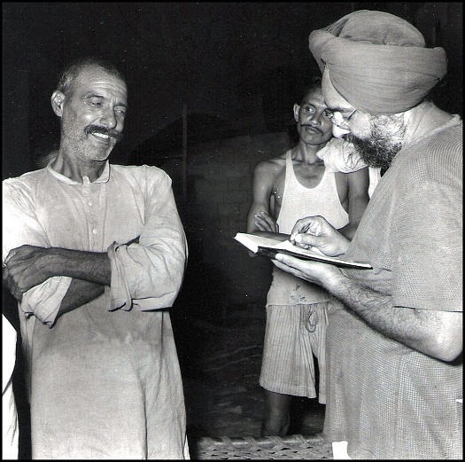 Khushwant Singh, right, as Editor of Yojana, journal of the Planning Commission. In Bhakra village, a villager (on the left) told Khushwant that he was aware, even as a young man, that one day a great dam would come up near his village. The Bhakra dam gets its name from this village, which was submerged in the waters of the Sutlej after the dam was built. (Photo: T.S. Nagarajan)